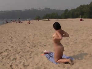 Beautiful teen plays at the beach nude