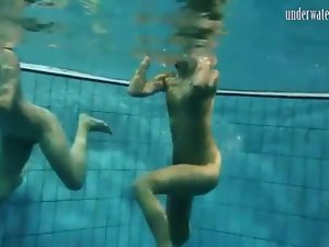 Two bikini beauties get naked in the pool