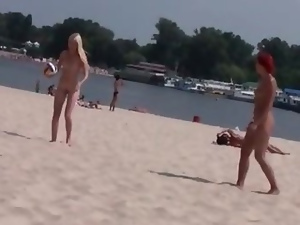 Two skinny nudist teens frolic around the beach