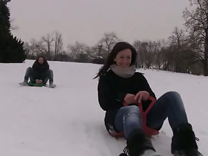 Two cute girls on a sled