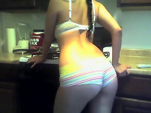 Boyshort panties cling to her ass in the kitchen