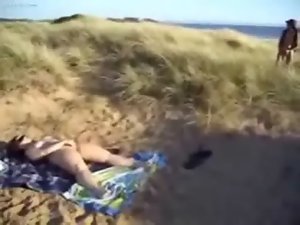 Sensual whore loves to be watched while she masturbates at beach
