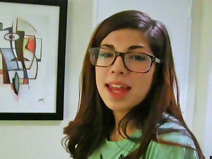 Ava Taylor wears her glasses while she plays with a penis